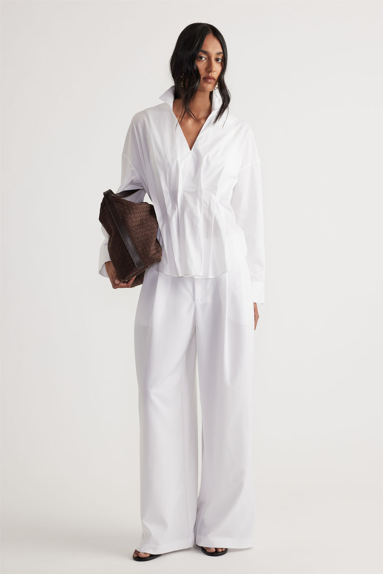 Clara Pleated Pant in white with wide-leg cut and high waist, styled with crisp white shirt by DECJUBA Australian fashion brand
