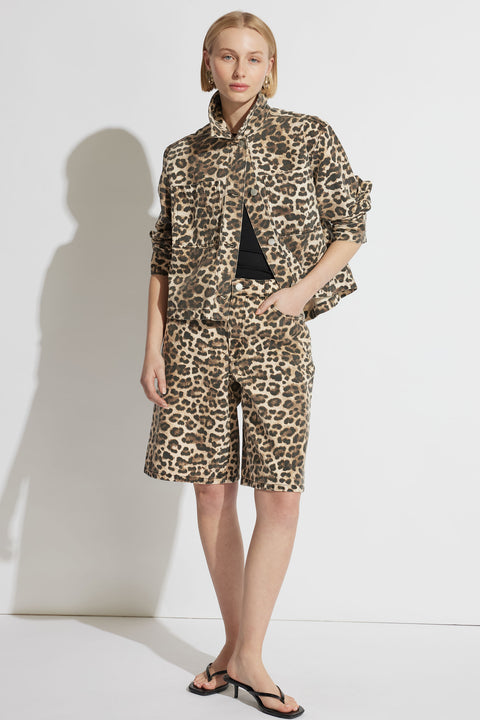 Woman wearing a relaxed leopard print denim jacket paired with matching long shorts and minimalist black sandals
