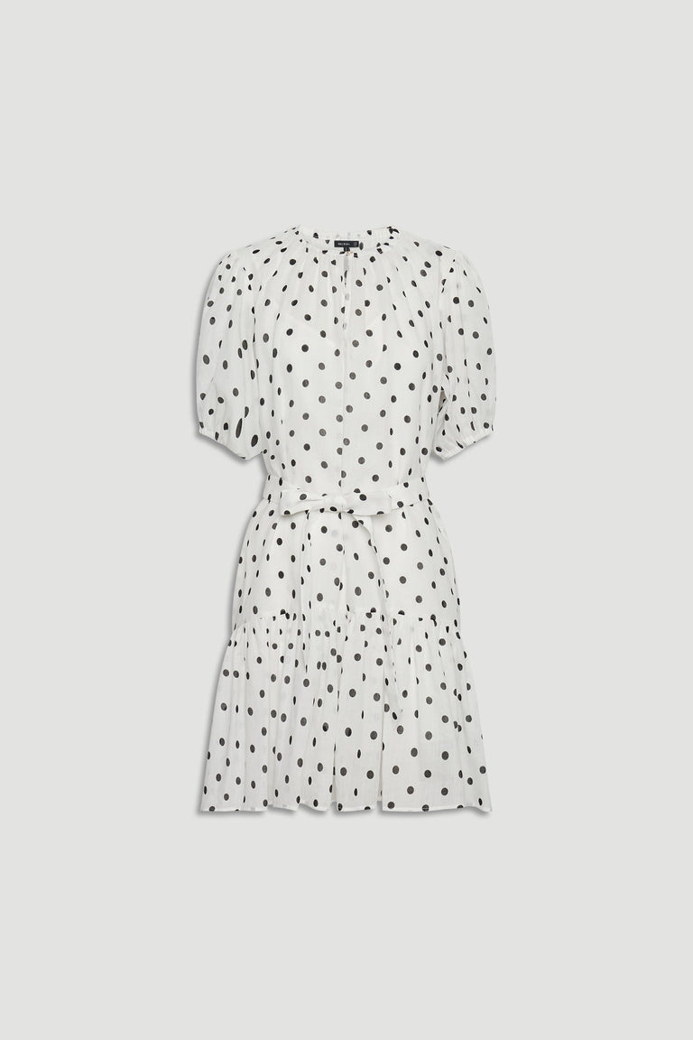 White mini dress with black polka dots, featuring puff sleeves, a cinched waist, and a gathered tiered skirt.