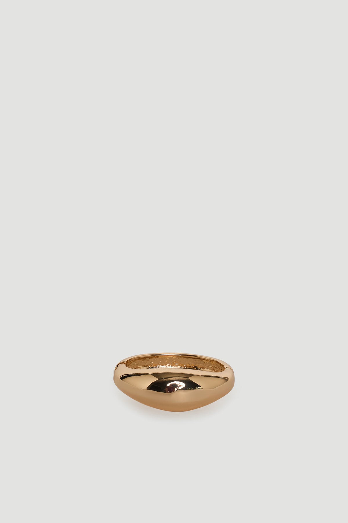 Smooth polished gold-tone bangle with a rounded, minimalist design for everyday versatile wear.