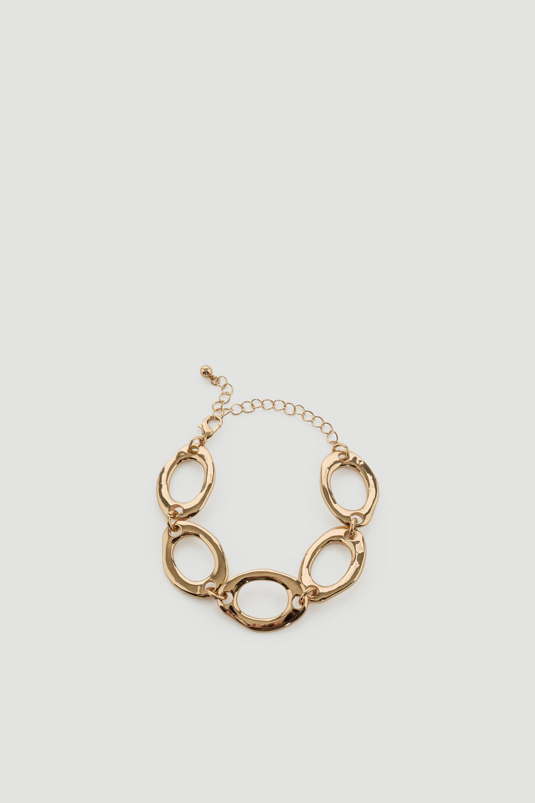 Gold-tone open chain bracelet with irregular oval links and adjustable clasp for versatile styling.