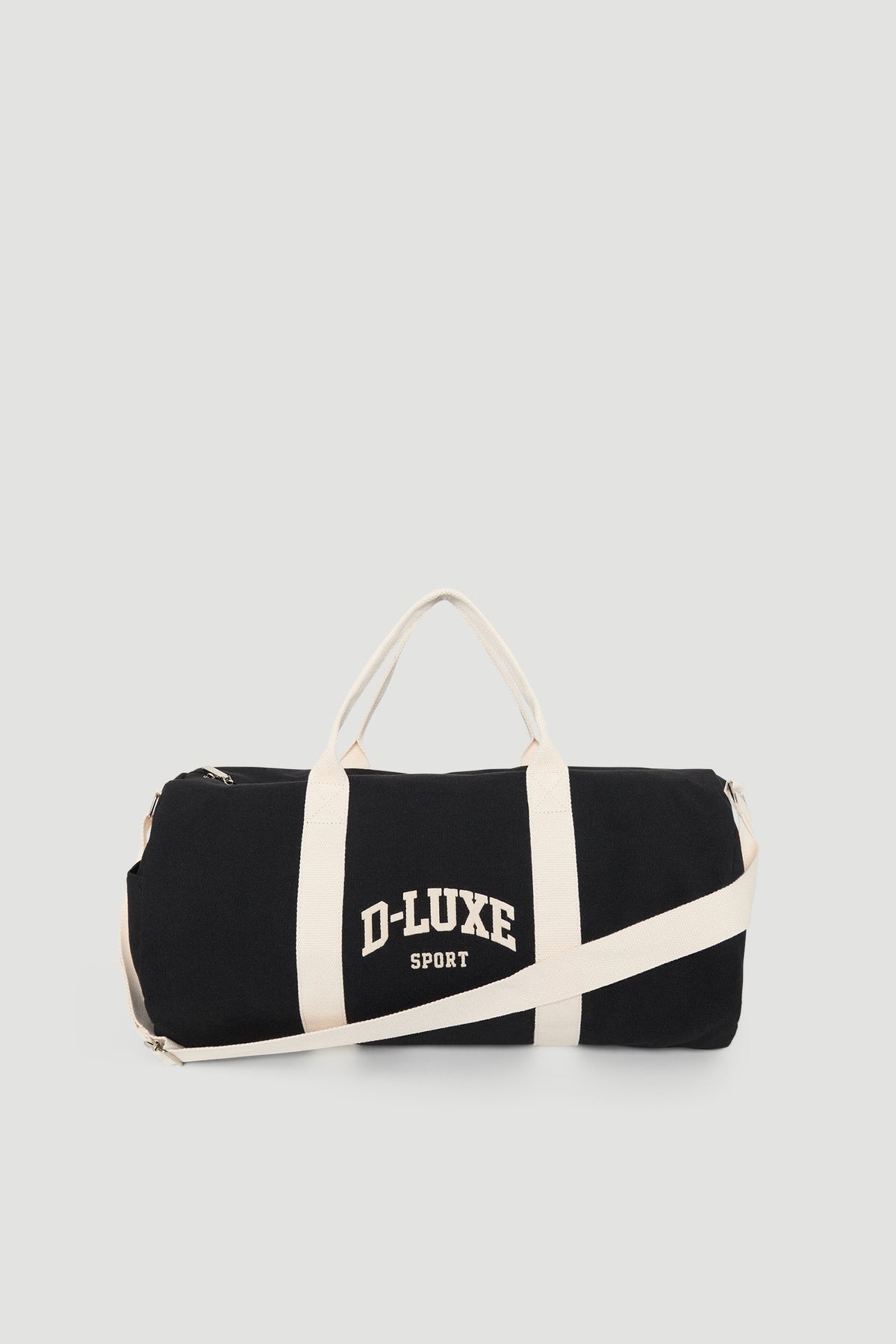 Black duffle bag with cream handles and shoulder strap, featuring bold "D-Luxe Sport" text for a sporty vibe.