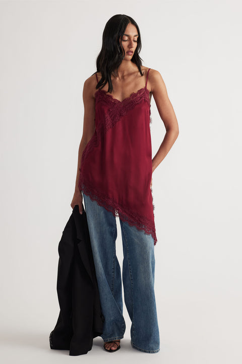 Woman wearing Karla Lace Tunic in deep red with lace trim and asymmetrical hem paired with wide-leg denim by Decjuba Australian brand