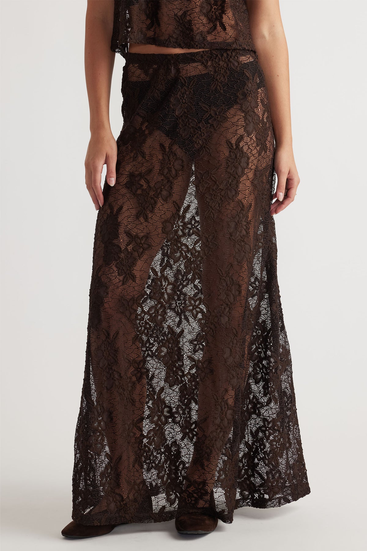 Brown lace maxi skirt with intricate floral pattern, offering an elegant and airy layered silhouette.