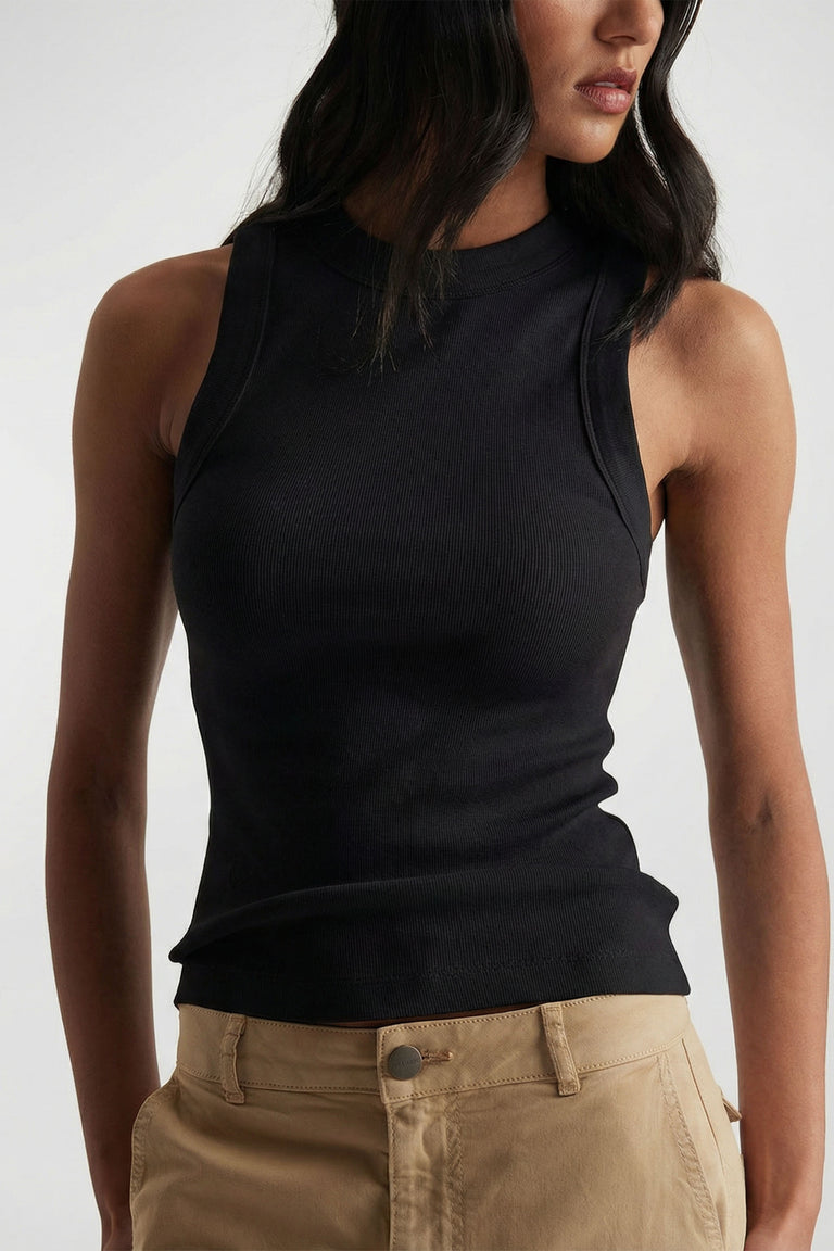 Charlotte Rib Tank in black ribbed knit, styled with beige pants, showcasing a sleek versatile look by DECJUBA Australian fashion brand