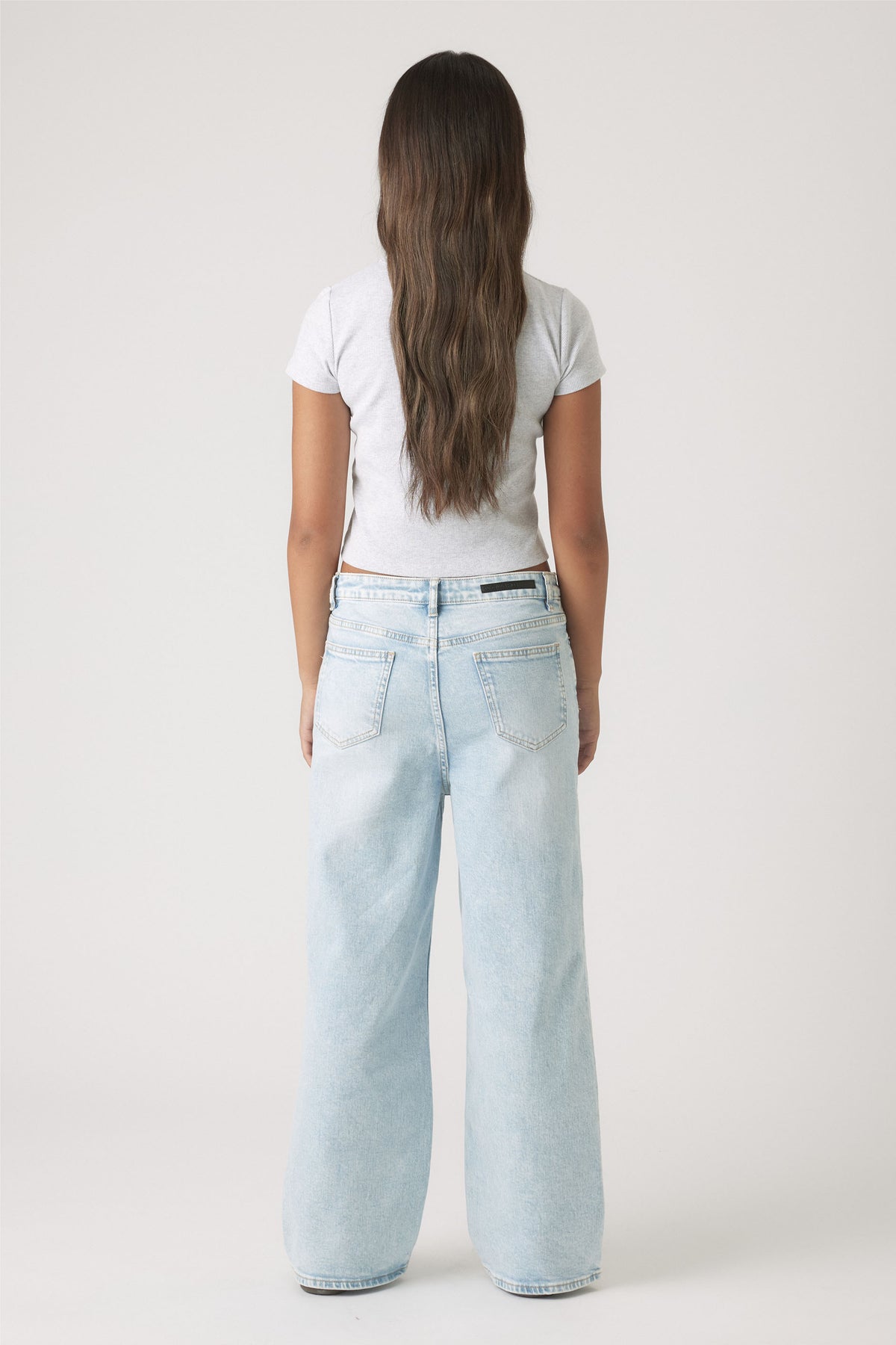 Back view of a girl wearing Girls Hailey Wide Leg Jean in light denim, relaxed fit and ankle length, gallery position 3.