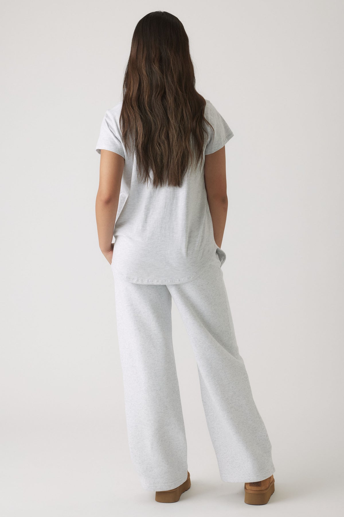 Girl wearing a soft light grey tee and wide-leg pants styled casually with relaxed fit and comfortable cut.