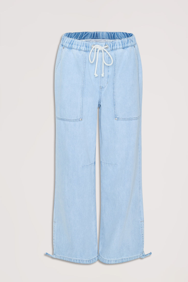 Light wash denim joggers featuring an elastic drawstring waist and relaxed wide-leg fit for casual comfort.