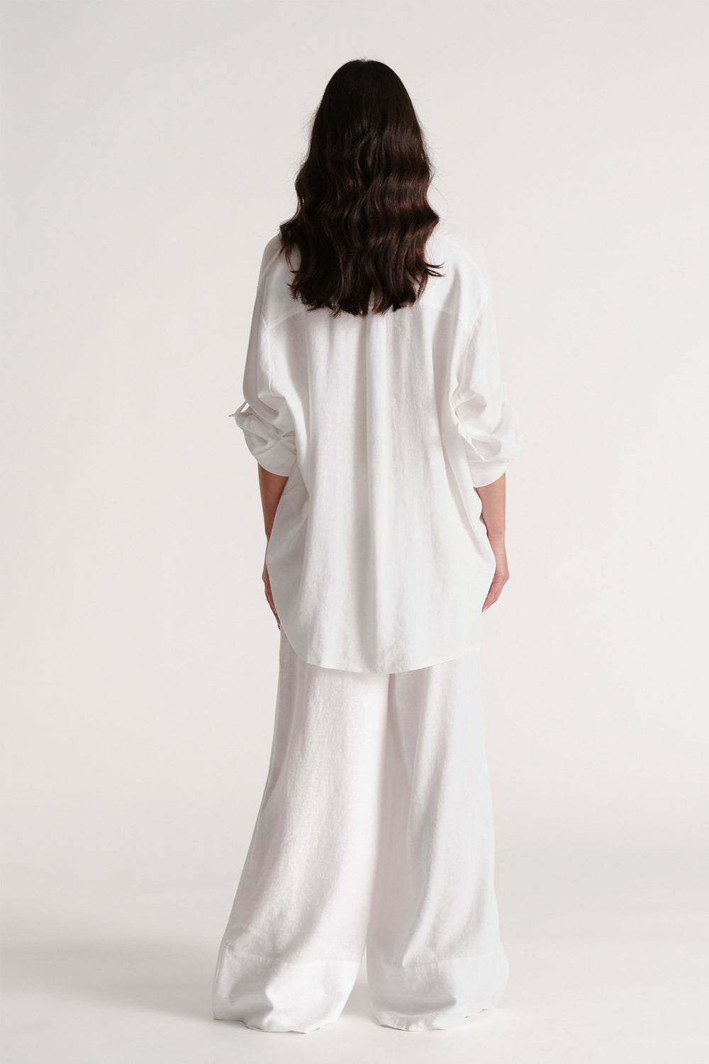 Portrait of model showcasing D-Luxe Linen Blend Pant in white, gallery position 3, highlighting breathability and softness.