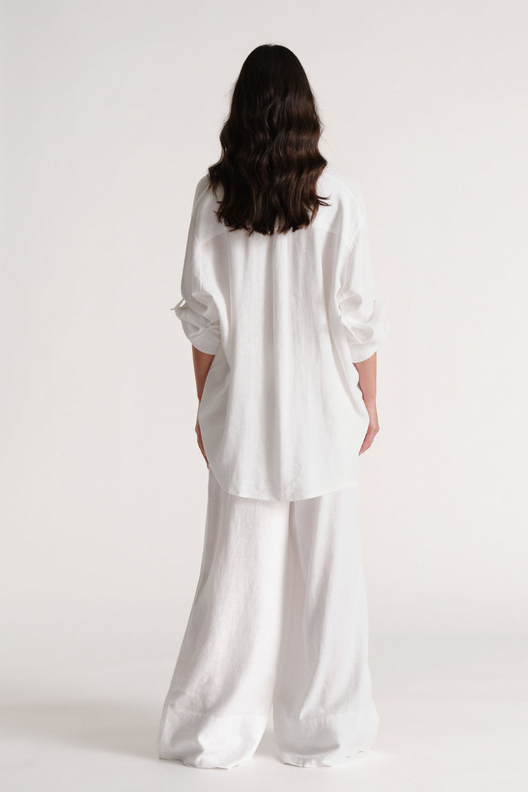 Portrait of model showcasing D-Luxe Linen Blend Pant in white, gallery position 3, highlighting breathability and softness.