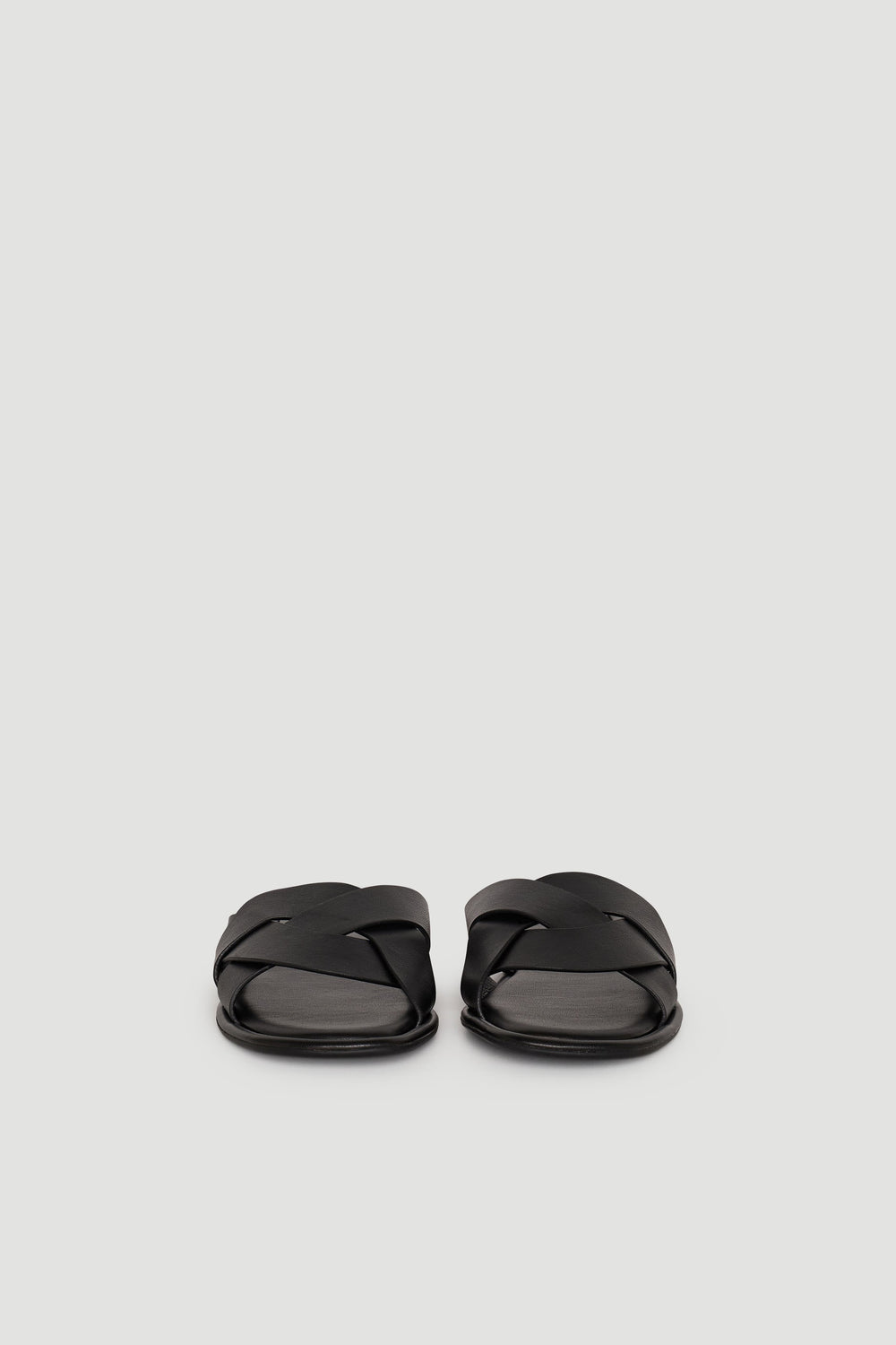 Pair of black Harper Slide sandals with wide, crisscross straps on a plain light background.