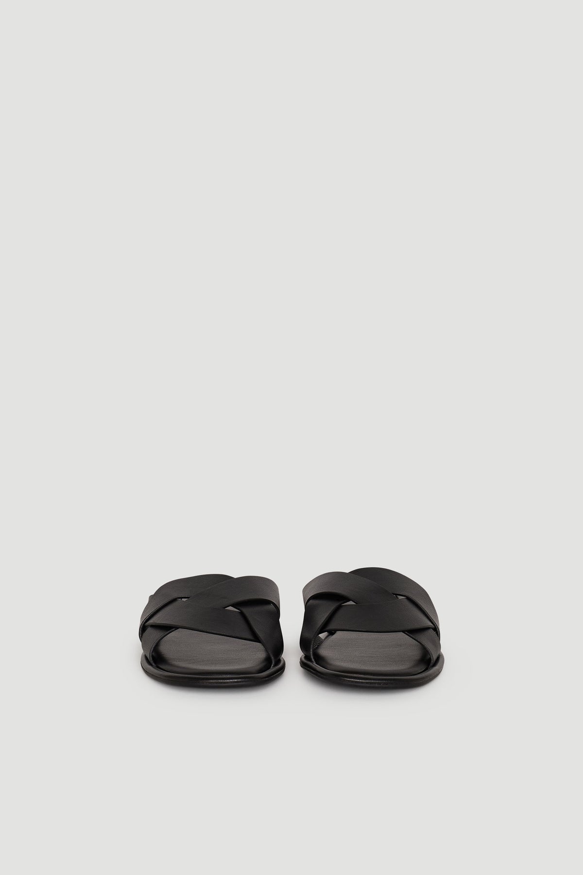 Pair of black Harper Slide sandals with wide, crisscross straps on a plain light background.