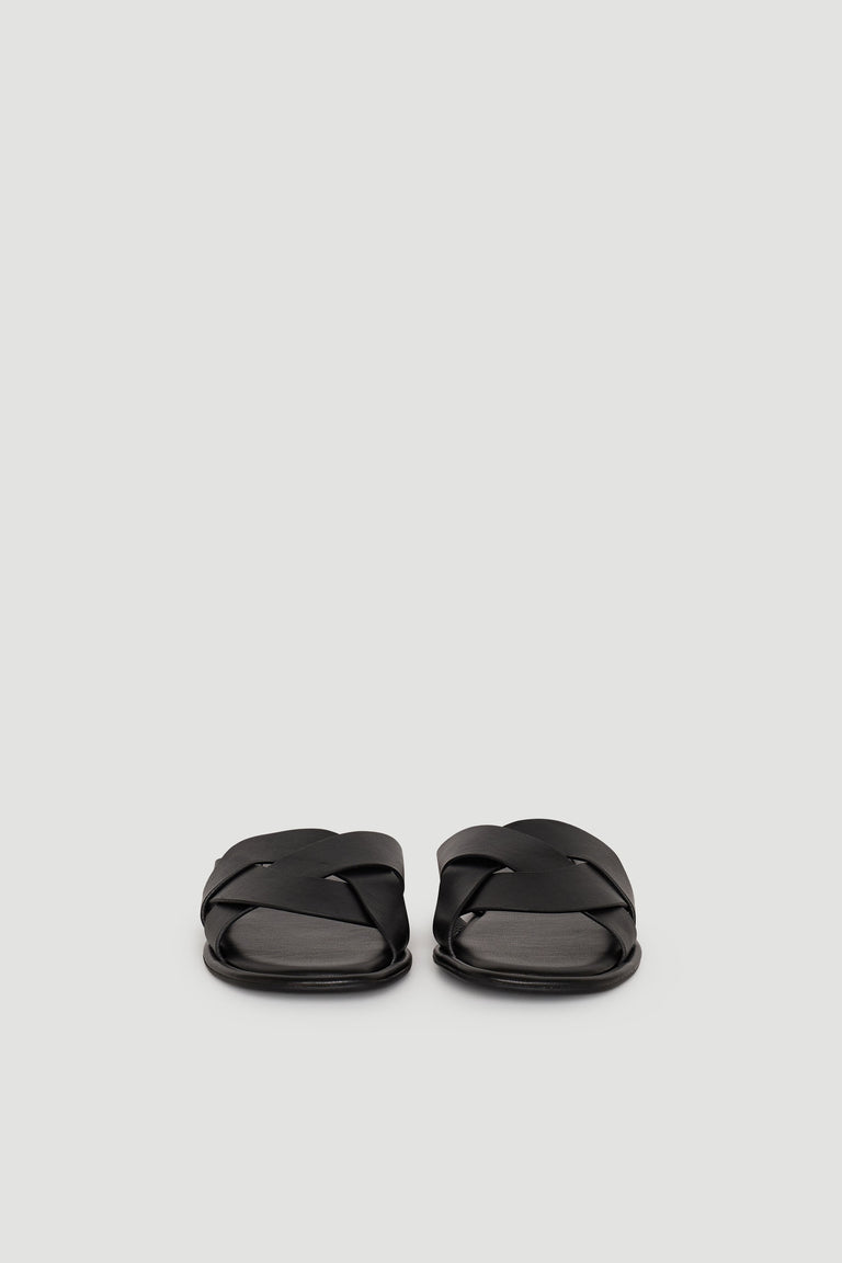 Pair of black Harper Slide sandals with wide, crisscross straps on a plain light background.