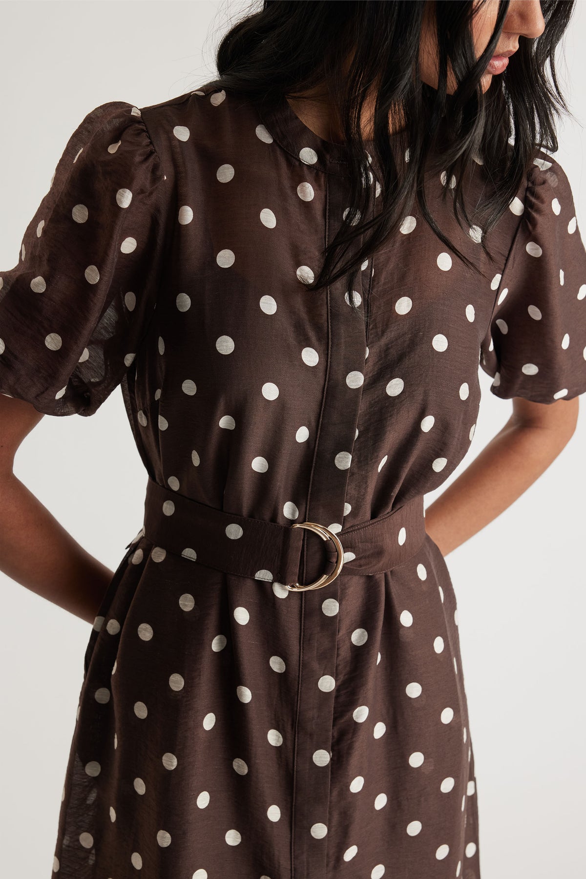 Close-up portrait of Becca Puff Sleeve Midi Dress in brown fabric with white polka dots and adjustable belt, gallery 2.