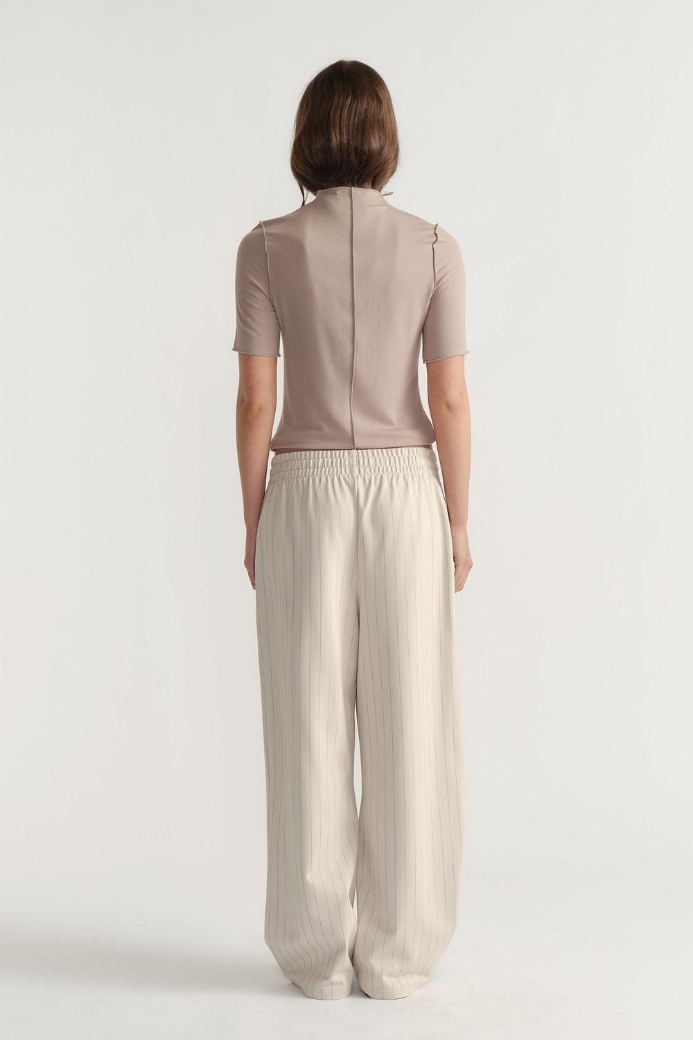 Back view of D-Luxe Pinstripe Pant in light beige with elastic waist and relaxed wide-leg fit by Decjuba Australian brand