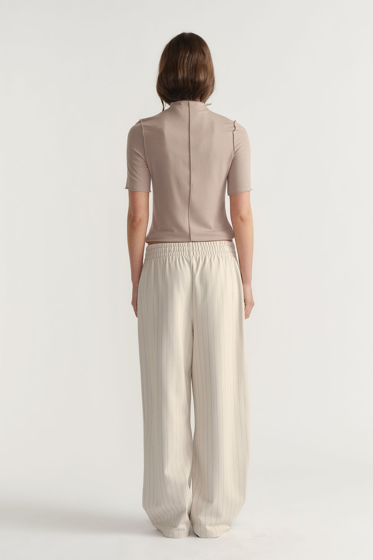 Back view of D-Luxe Pinstripe Pant in light beige with elastic waist and relaxed wide-leg fit by Decjuba Australian brand