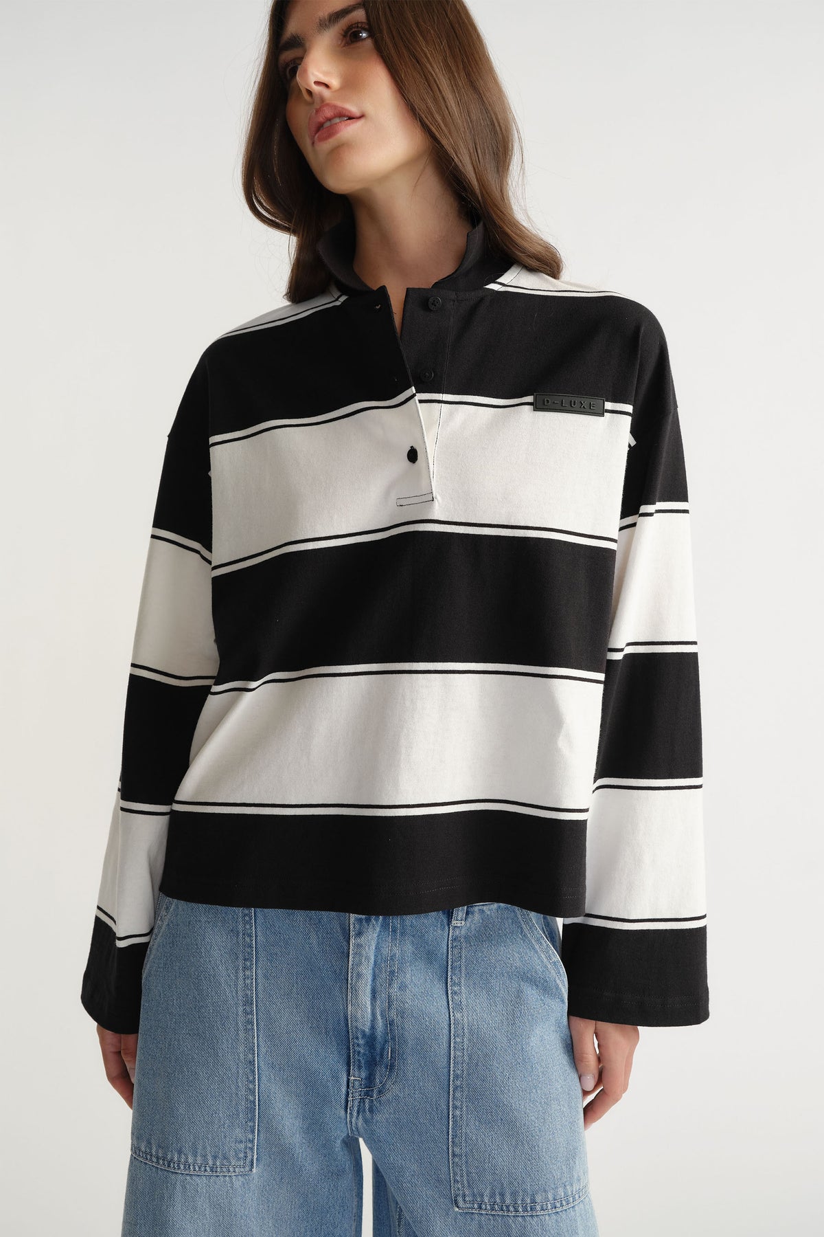 Woman wearing D-Luxe Stripe Polo in 100% cotton with black and white wide stripes by DECJUBA Australian fashion brand