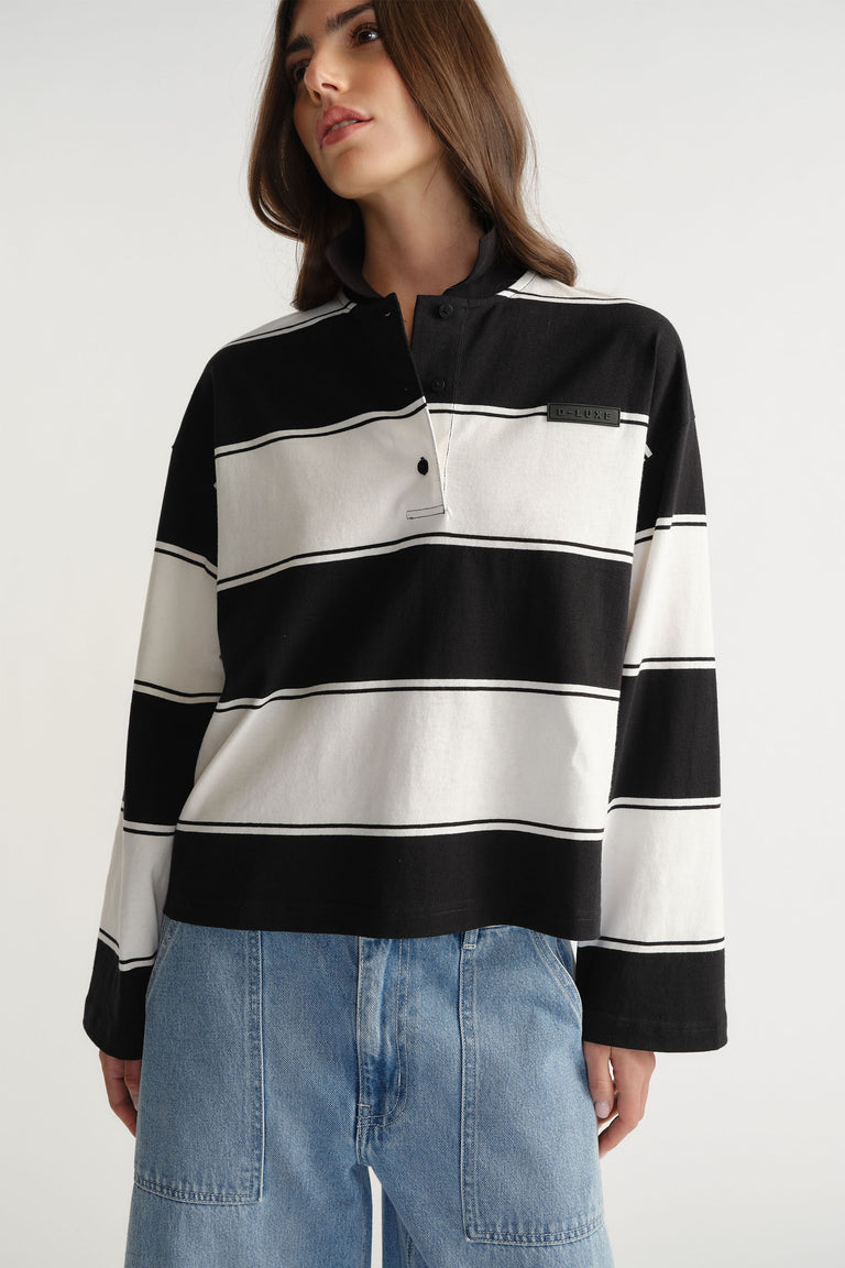 Woman wearing D-Luxe Stripe Polo in 100% cotton with black and white wide stripes by DECJUBA Australian fashion brand