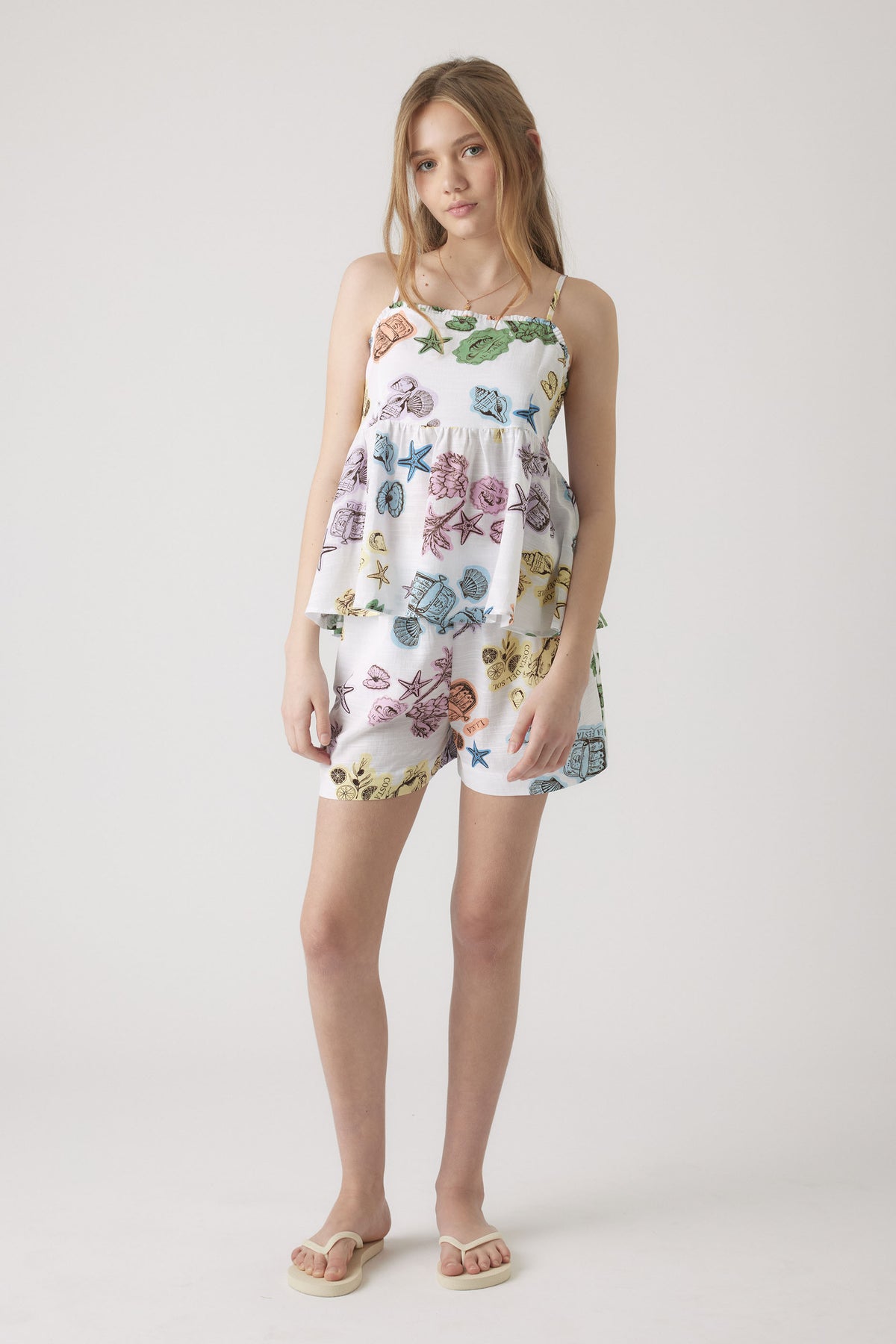 Girl wearing Girls Millie Beach Short with elastic waist and colorful beach print, gallery position 1 portrait view