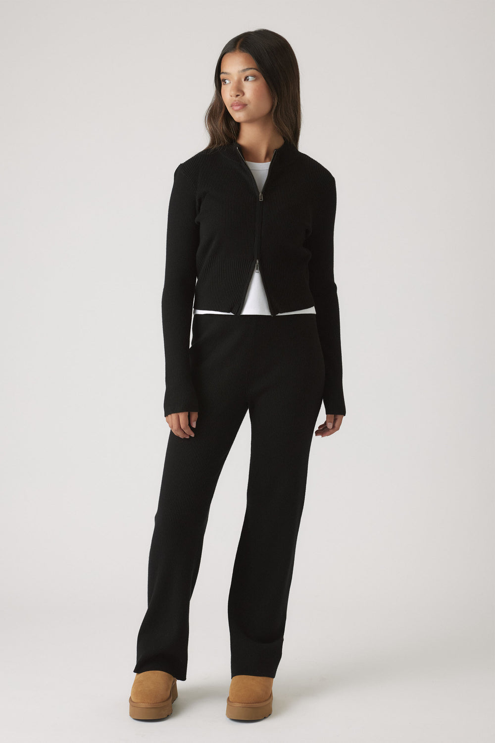 Girls Matilda Knit Pant in sleek black knitwear paired with a matching zip-up top and tan boots by DECJUBA Australian brand