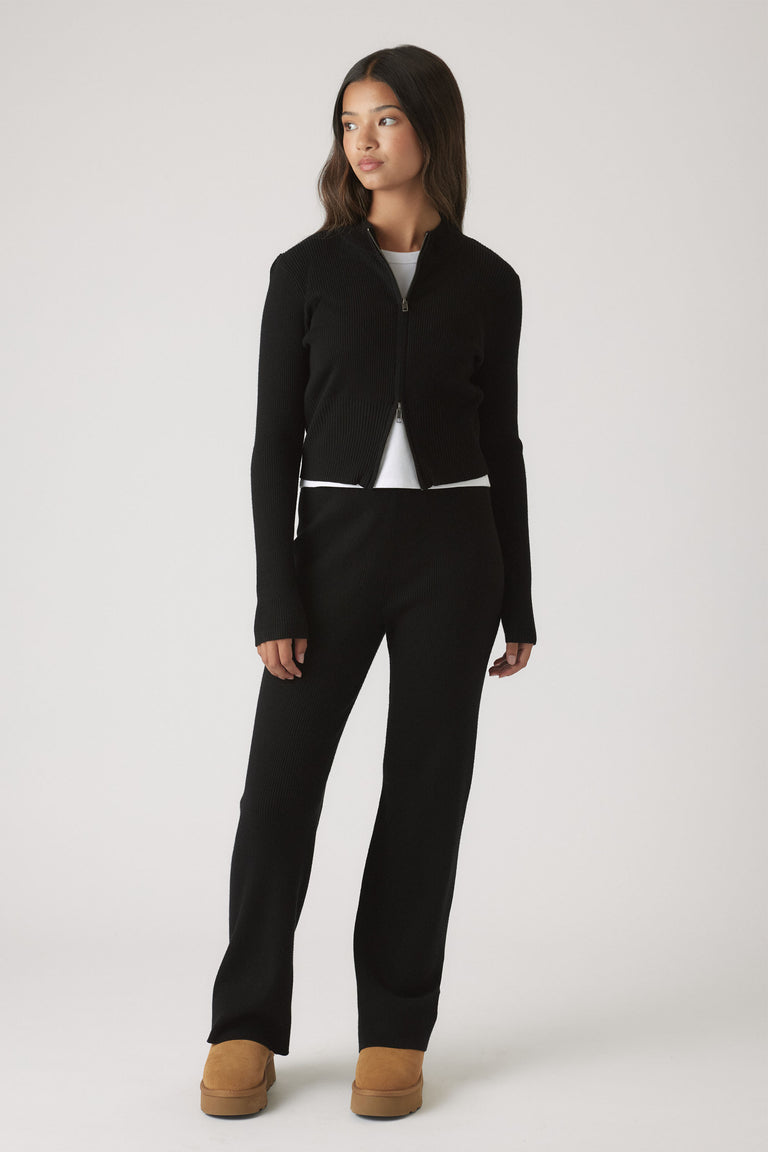 Girls Matilda Knit Pant in sleek black knitwear paired with a matching zip-up top and tan boots by DECJUBA Australian brand