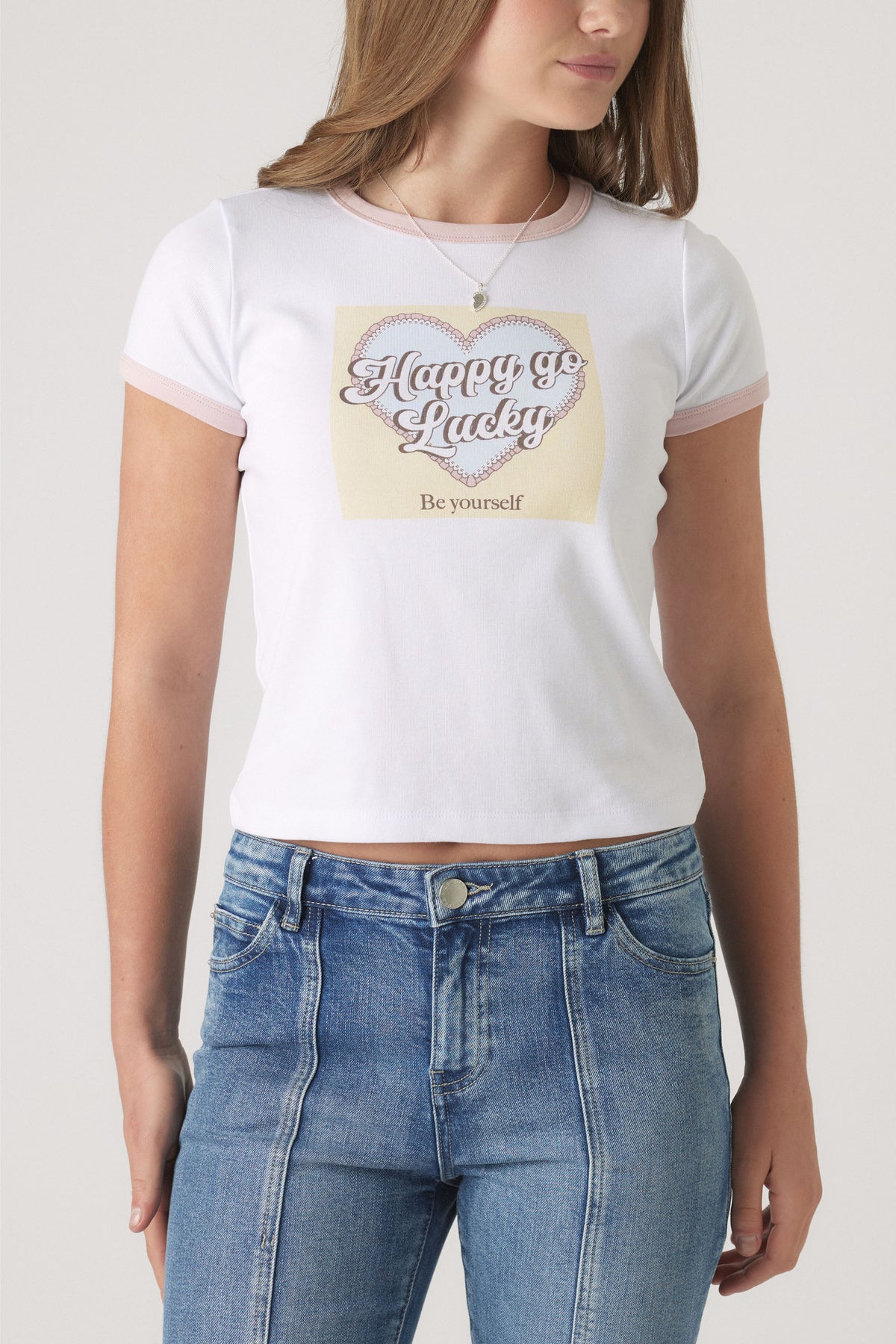 Girls Cropped Ringer Tee in white with blush trim and graphic heart print styled with blue high-waist denim by DECJUBA Australian brand