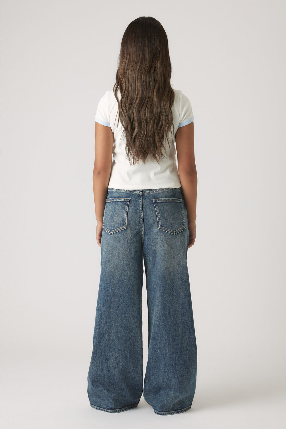 Girls Cropped Ringer Tee in white with light blue trim, styled with wide-leg denim jeans for a relaxed look by DECJUBA Australian brand