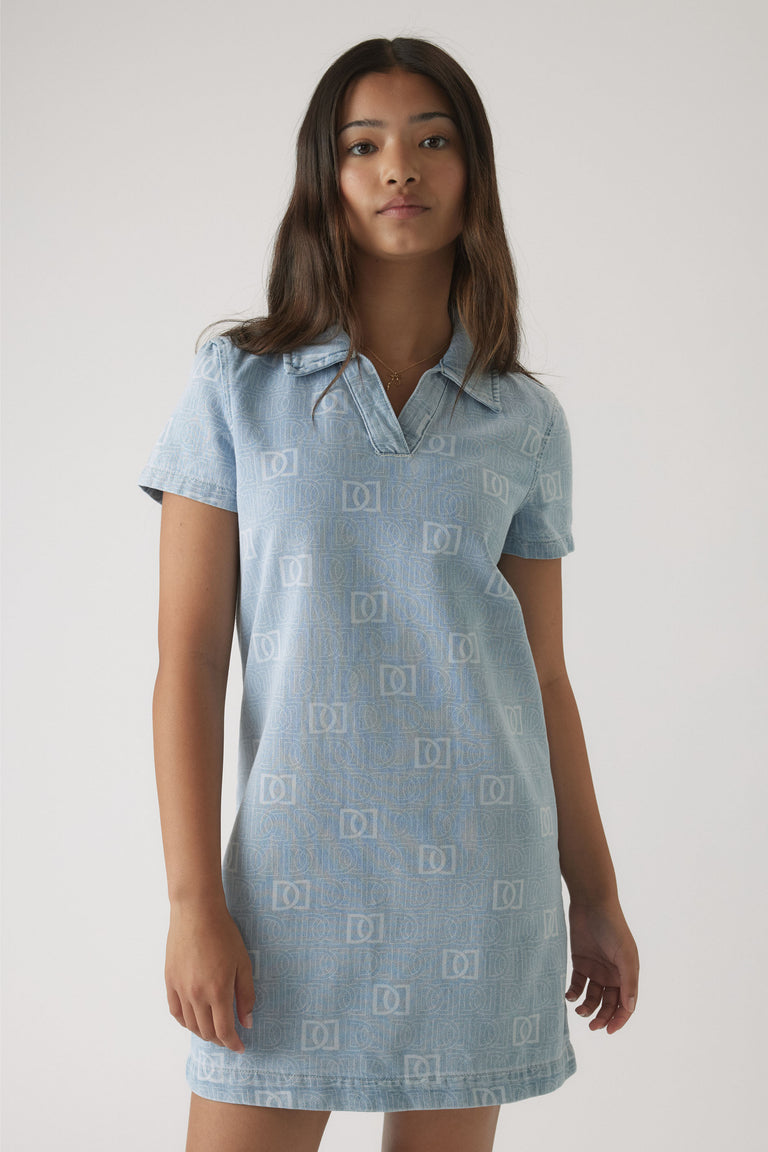 Girl wearing a light blue short-sleeve denim dress with a subtle all-over monogram print and a relaxed collar neckline