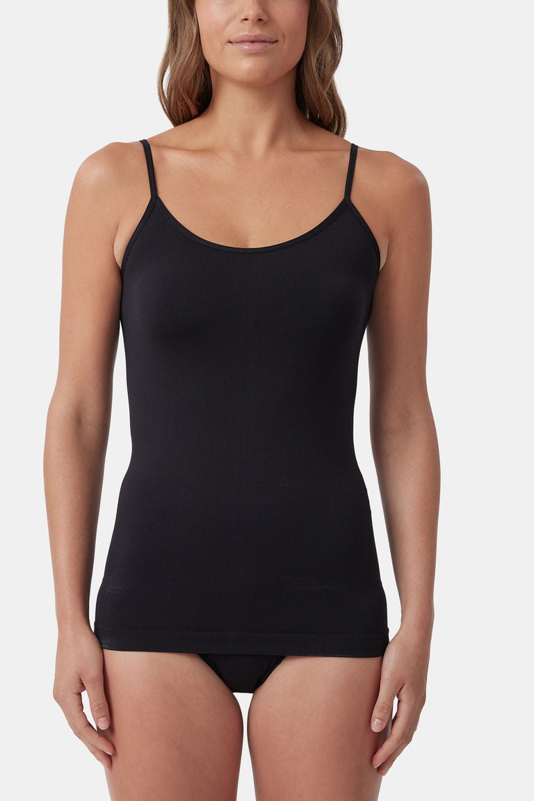 Woman wearing a fitted black seamless tank with thin straps, styled for an effortless and versatile everyday look.