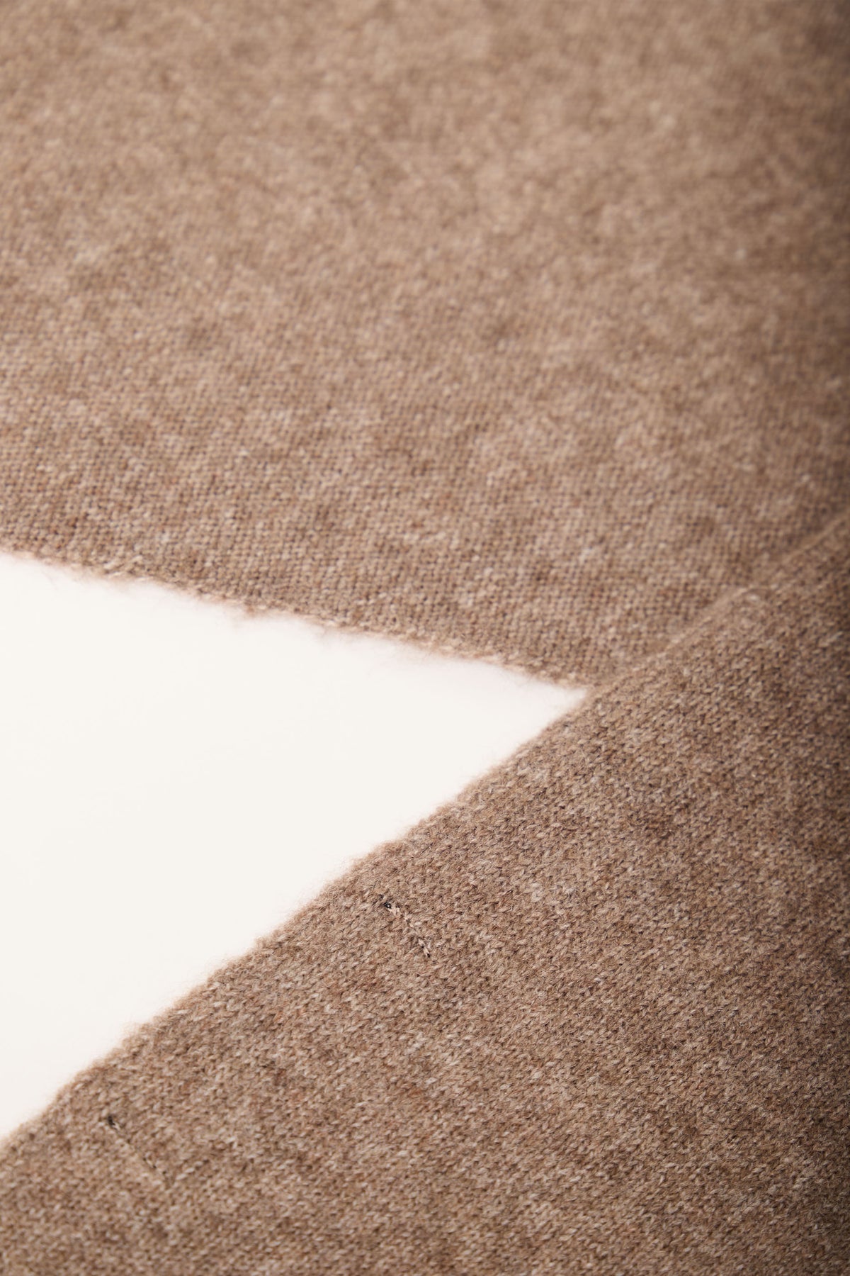 Close-up of soft, warm cocoa brown Heather Triangle Scarf fabric showcasing fine texture and neat edges.