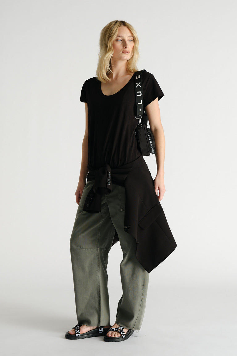 Woman wearing black D-Luxe Slub Tee styled with olive pants, black jacket, and branded accessories by Decjuba Australian fashion brand