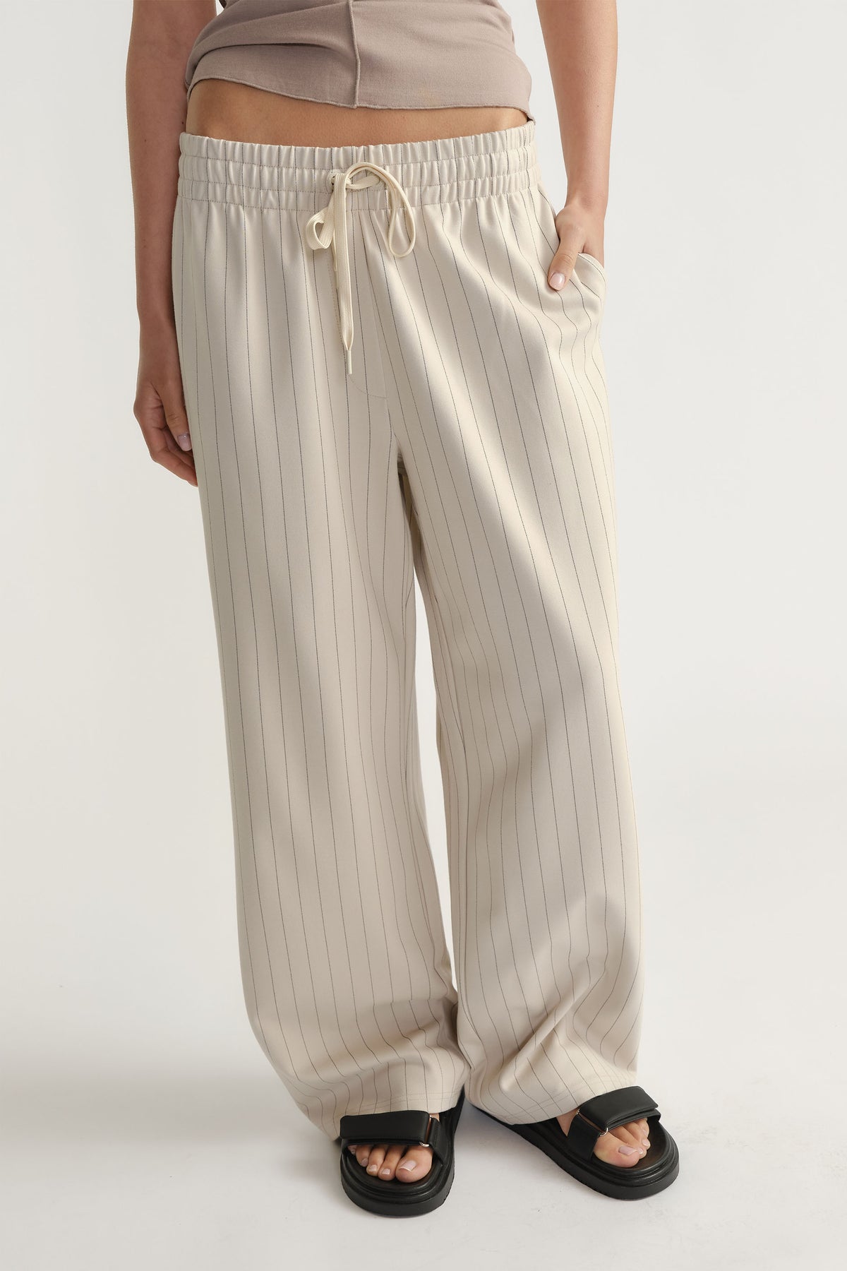 Front view of D-Luxe Pinstripe Pant in light beige with elastic waistband and relaxed wide-leg fit by Decjuba Australian brand
