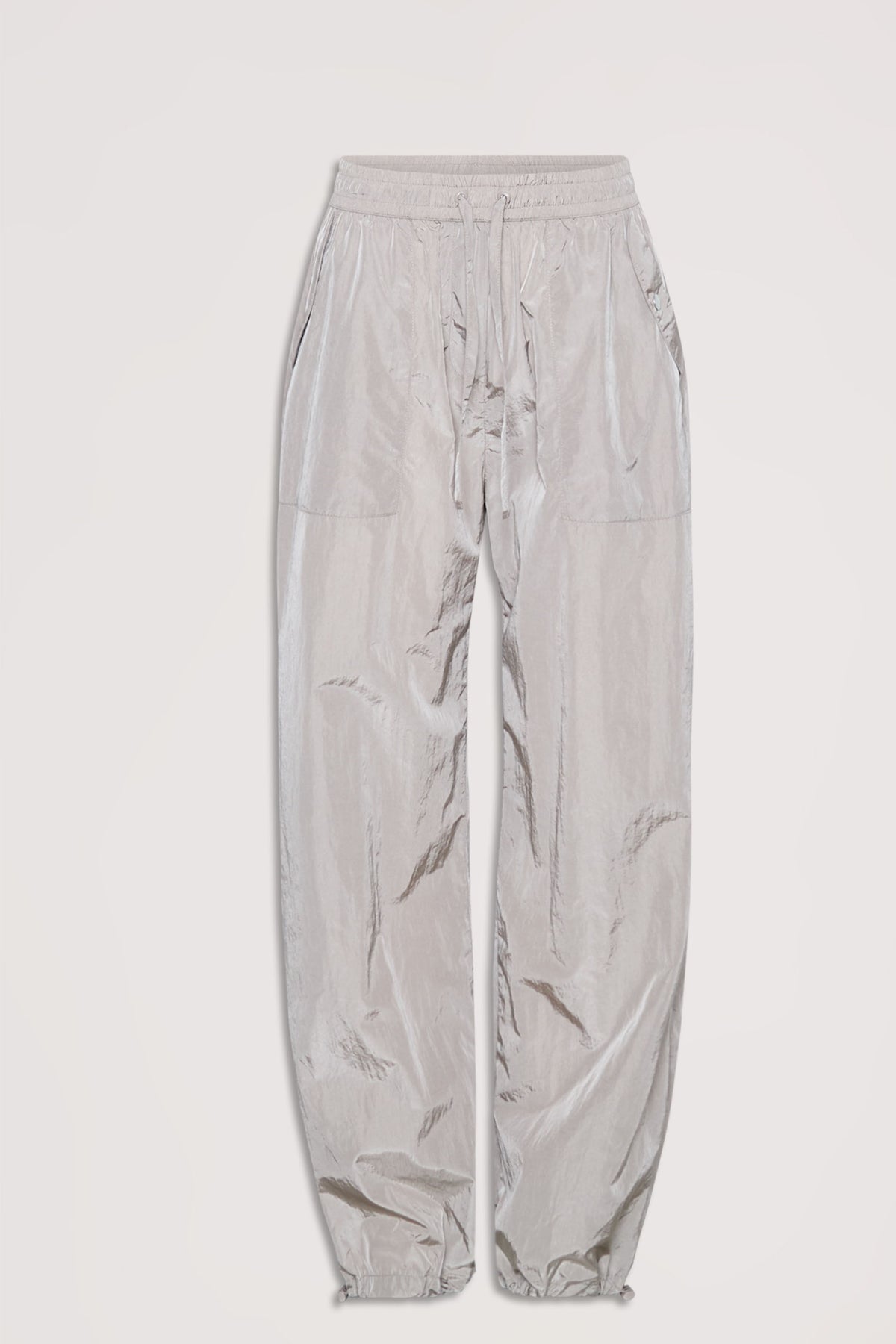 Light gray parachute-style jogger pants with elastic waistband, drawstring ties, and slip pockets, laid flat on white background.