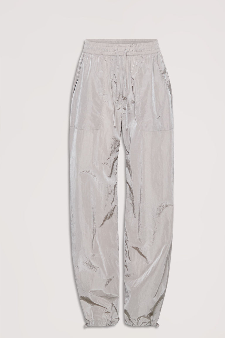 Light gray parachute-style jogger pants with elastic waistband, drawstring ties, and slip pockets, laid flat on white background.