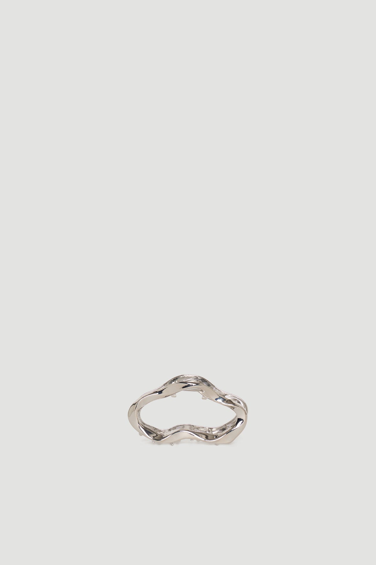 Silver-toned hair claw with a wavy, organic shape for a stylish and effortless hair accessory.