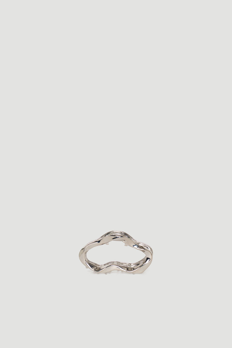 Silver-toned hair claw with a wavy, organic shape for a stylish and effortless hair accessory.
