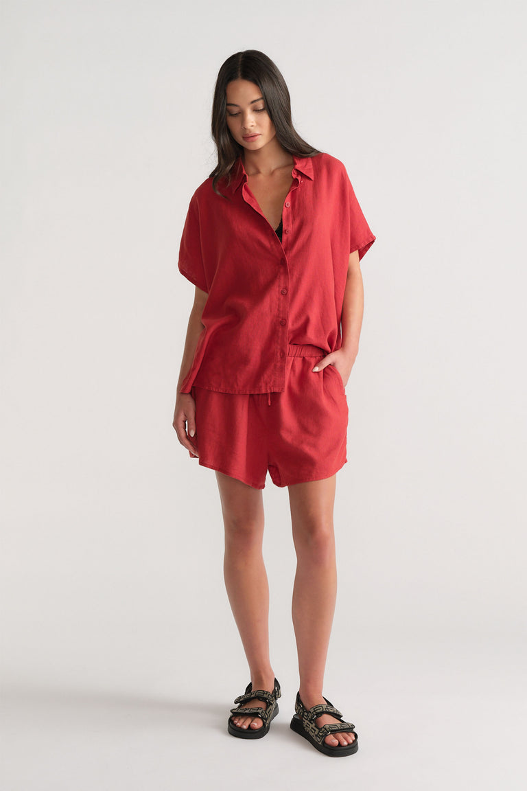 Woman wearing red D-Luxe Linen Blend Flip Short and matching shirt, standing in portrait orientation, gallery image 1