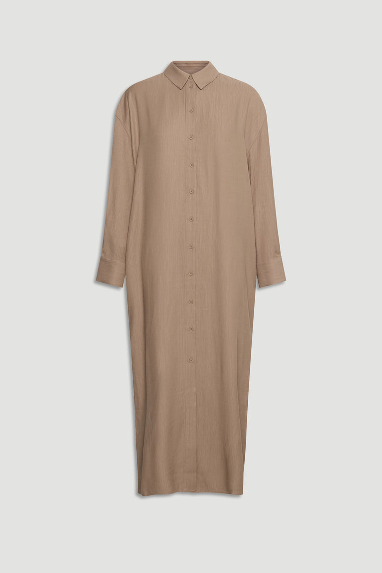 Long textured shirt dress in warm beige with full button front and classic collar for effortless style.