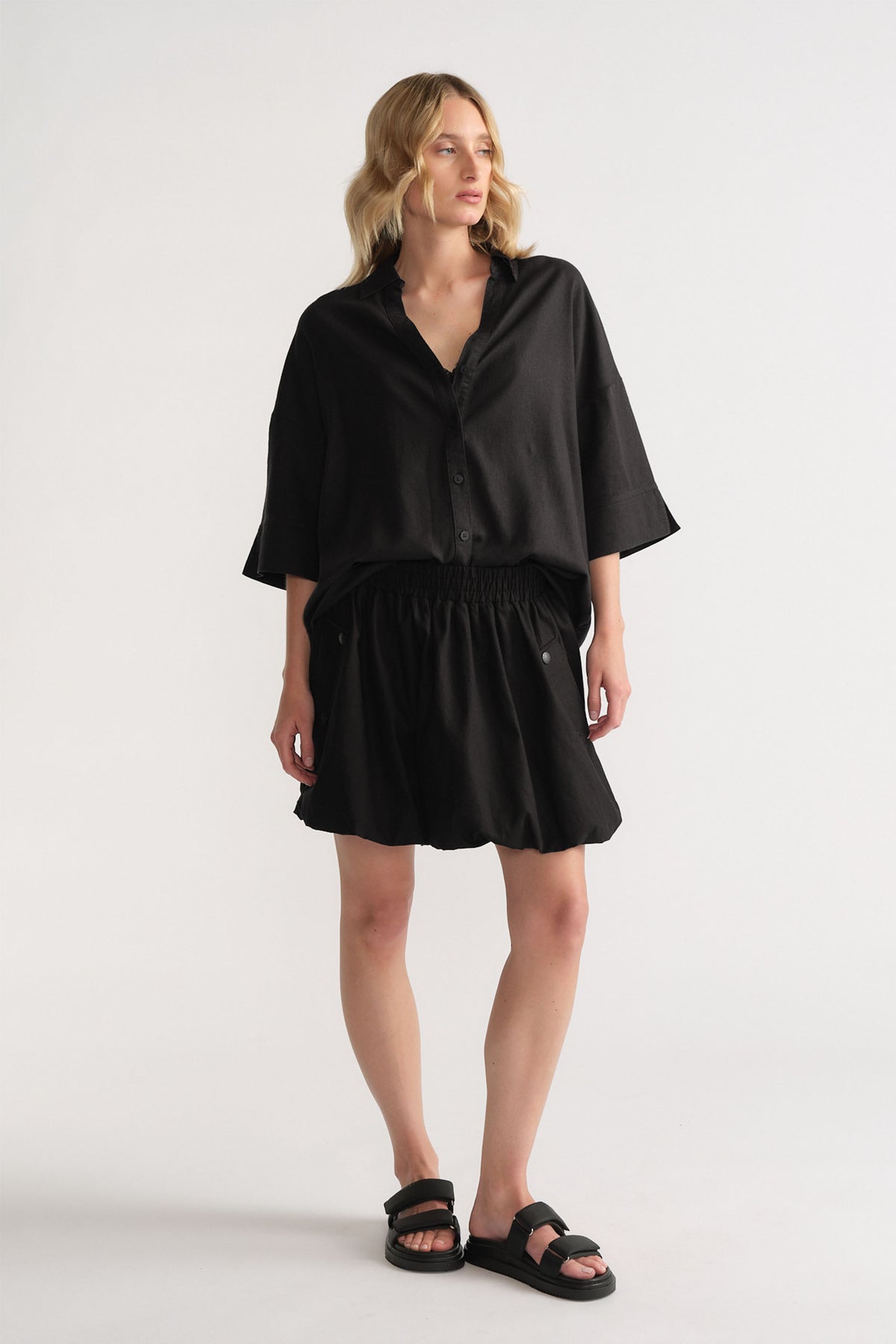 Gallery 1 portrait of D-Luxe Linen Blend 3/4 Shirt in black, styled with a matching skirt and sandals