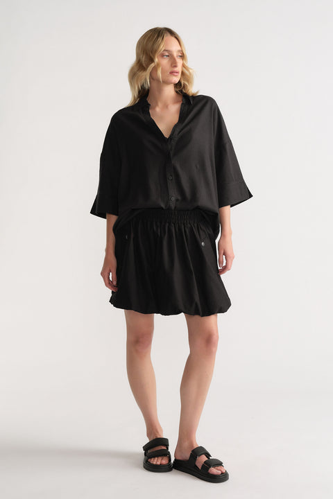 Gallery 1 portrait of D-Luxe Linen Blend 3/4 Shirt in black, styled with a matching skirt and sandals