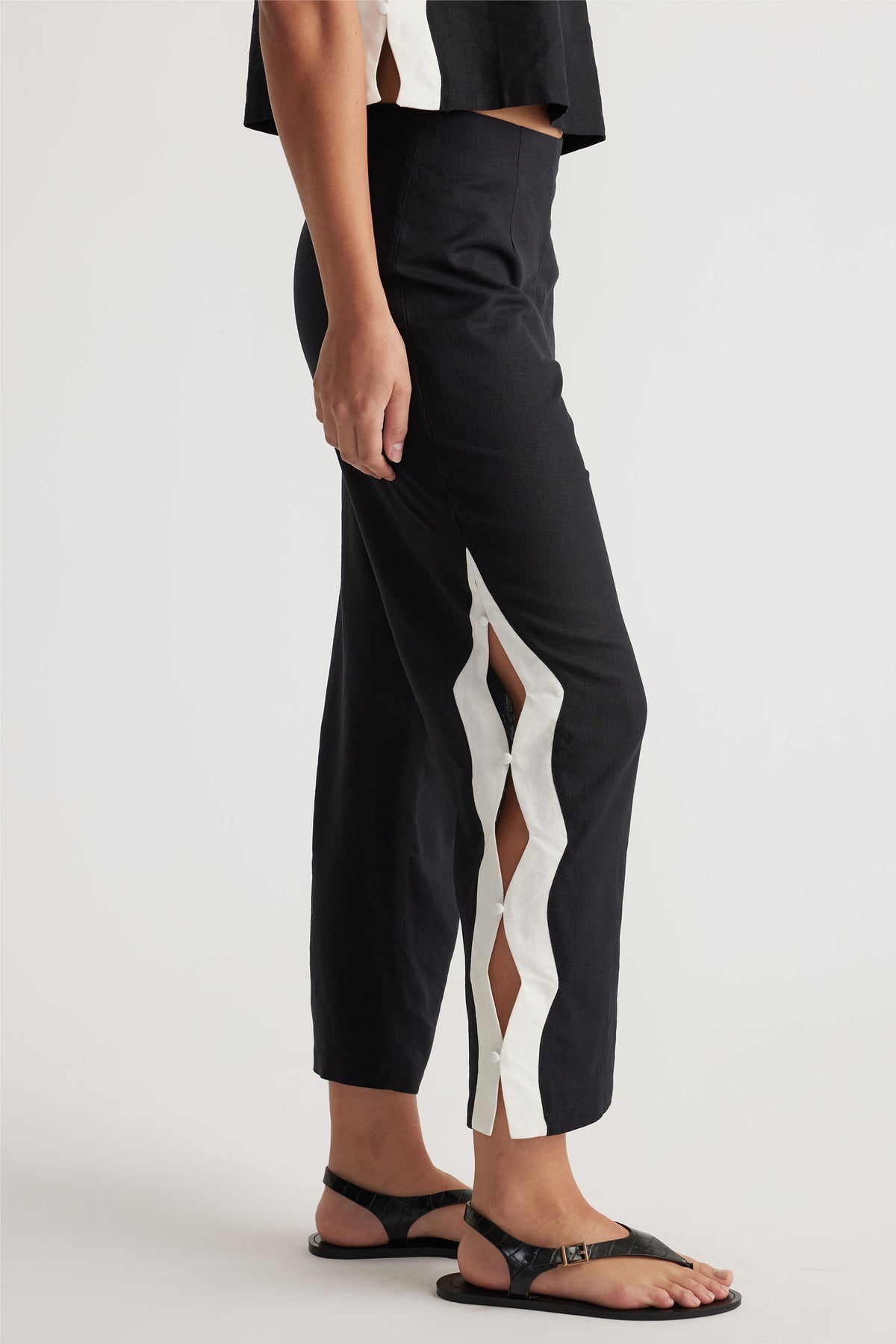 Tess Scallop Pant in black with contrast white scalloped edge and button side splits, shown in gallery position 2 portrait view