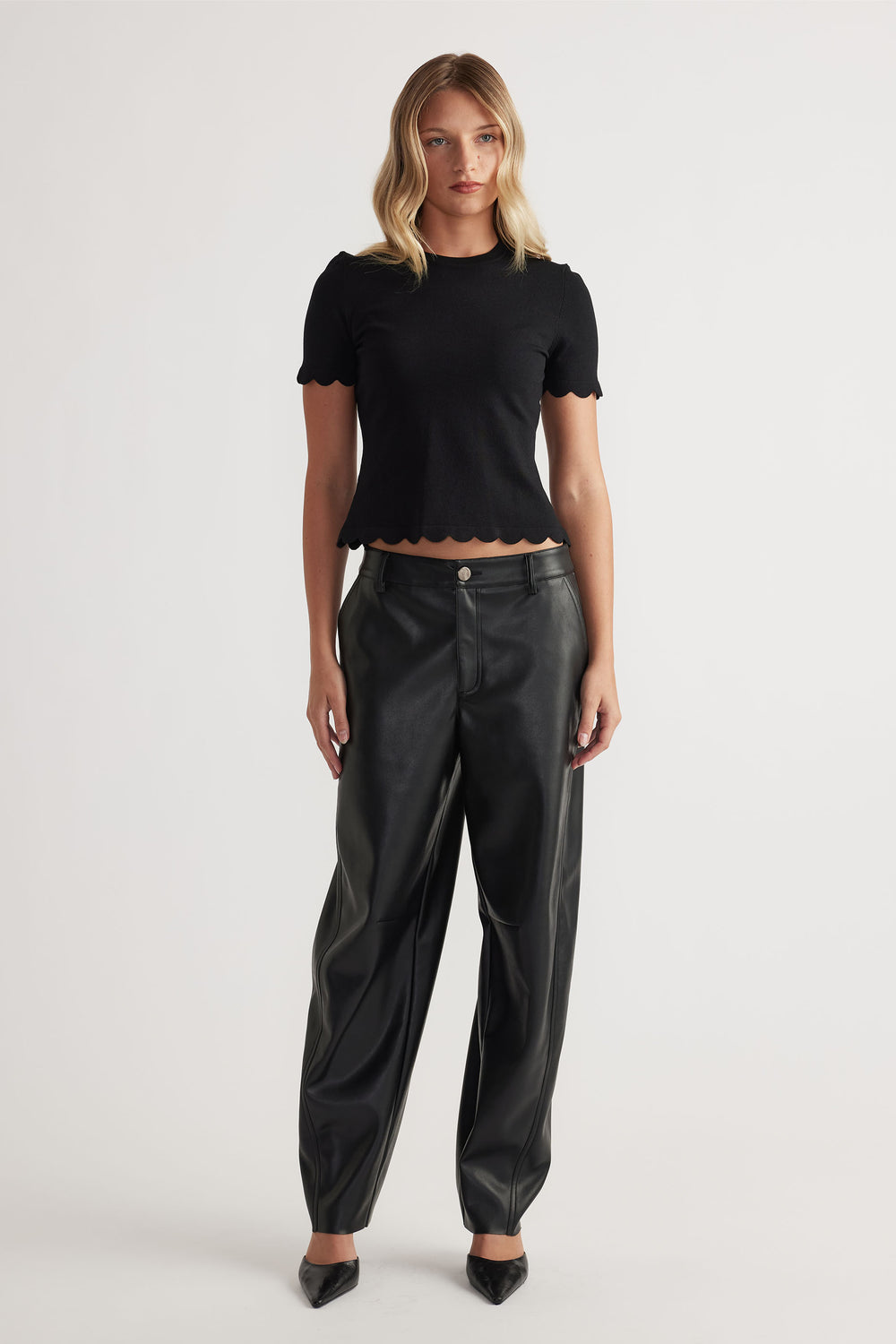 Woman wearing black Kai Scallop Edge Tee in 52% LENZING™ ECOVERO™ Viscose 48% Recycled Nylon by DECJUBA Australian brand