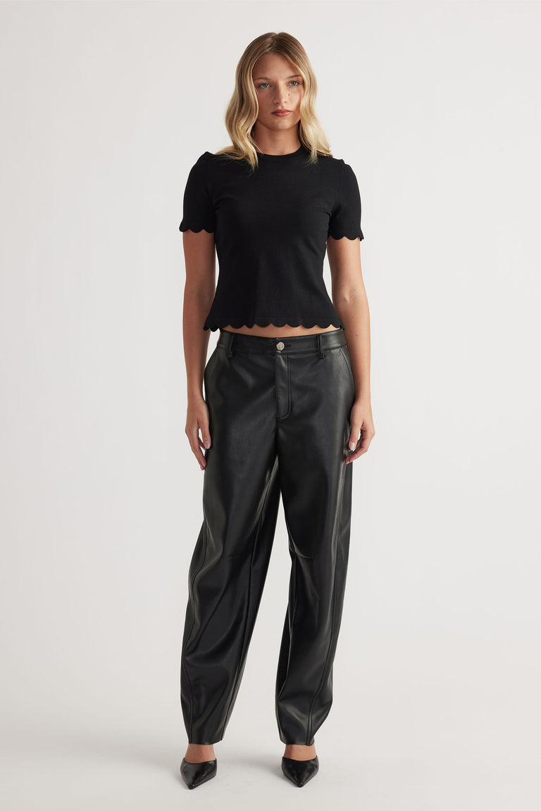 Woman wearing black Kai Scallop Edge Tee in 52% LENZING™ ECOVERO™ Viscose 48% Recycled Nylon by DECJUBA Australian brand