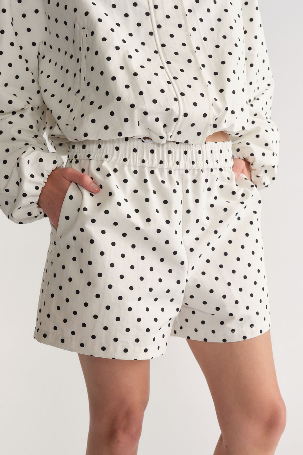 D-Luxe Polka Dot Short in white with black dots, elastic waist and pockets, styled casually by DECJUBA Australian fashion brand