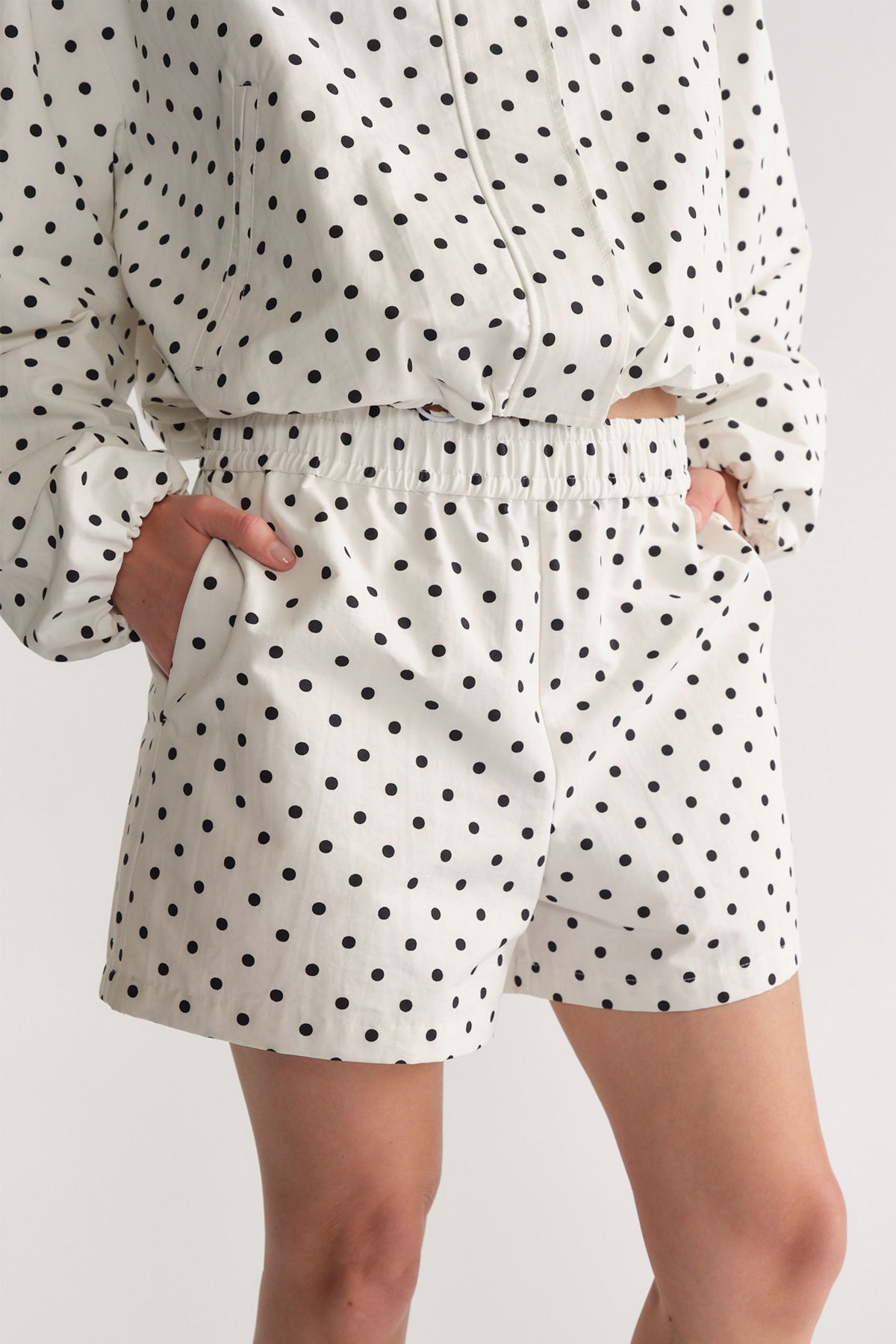 D-Luxe Polka Dot Short in white with black dots, elastic waist and pockets, styled casually by DECJUBA Australian fashion brand