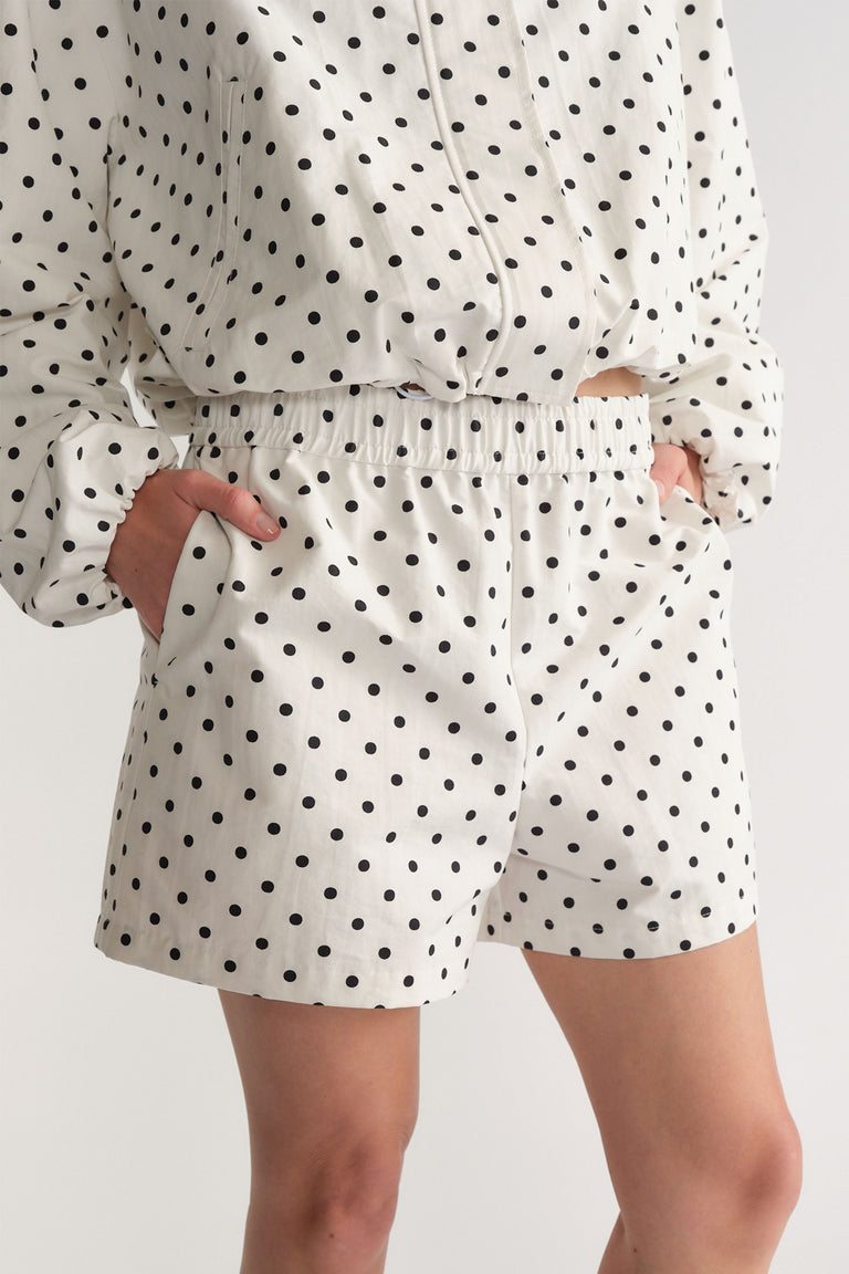 D-Luxe Polka Dot Short in white with black dots, elastic waist and pockets, styled casually by DECJUBA Australian fashion brand