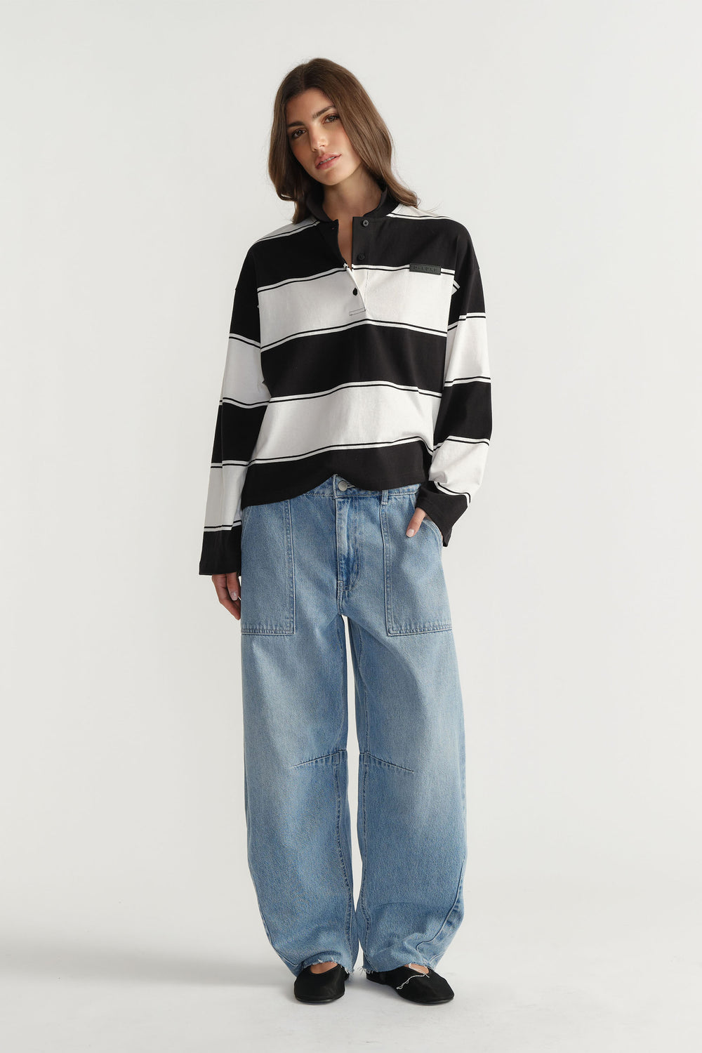 Woman wearing D-Luxe Stripe Polo in 100% cotton with black and white horizontal stripes by DECJUBA Australian fashion brand