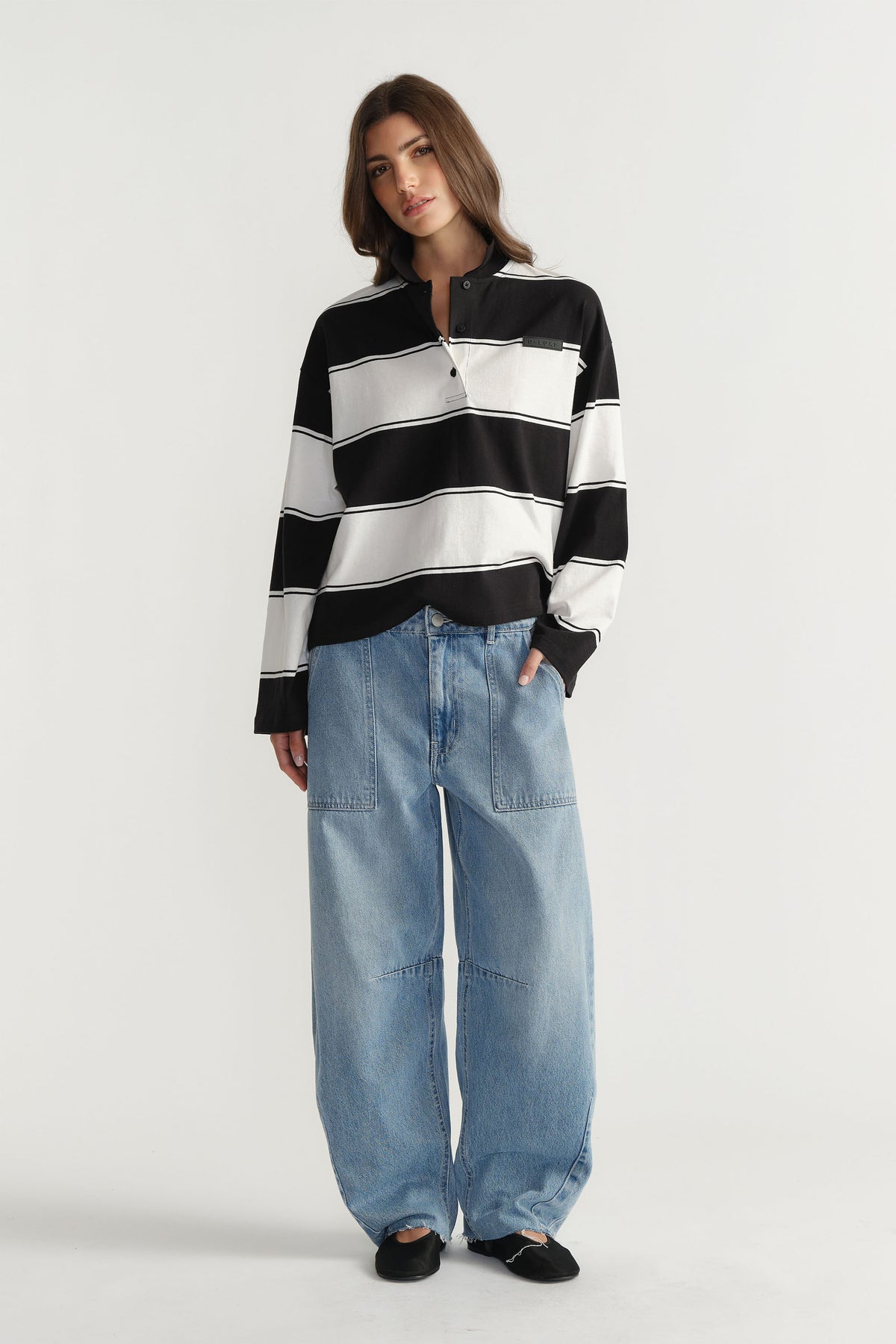 Woman wearing D-Luxe Stripe Polo in 100% cotton with black and white horizontal stripes by DECJUBA Australian fashion brand