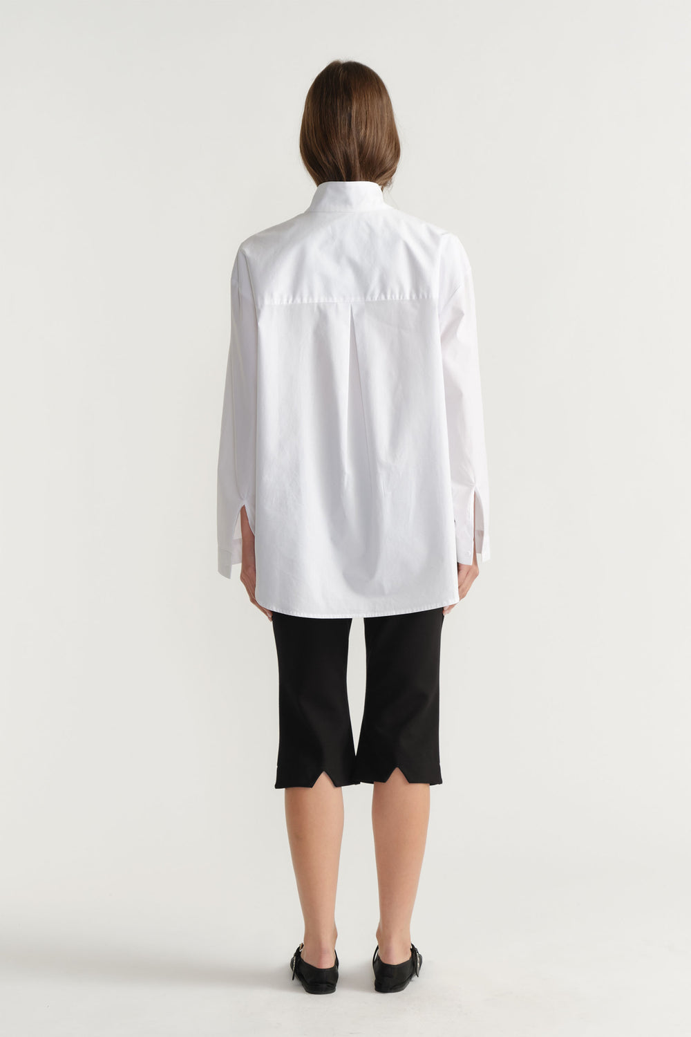 Rear view of woman wearing D-Luxe Button Up Shirt in 100% cotton paired with black pants by DECJUBA Australian fashion brand