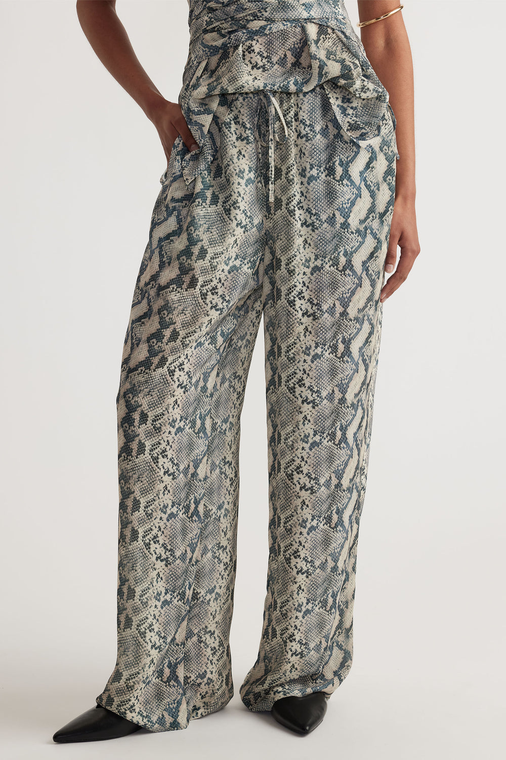 Ilaria Yoryu Pant in gallery 2 with snake print, elastic waistband, drawcord, side pockets, and relaxed fit.